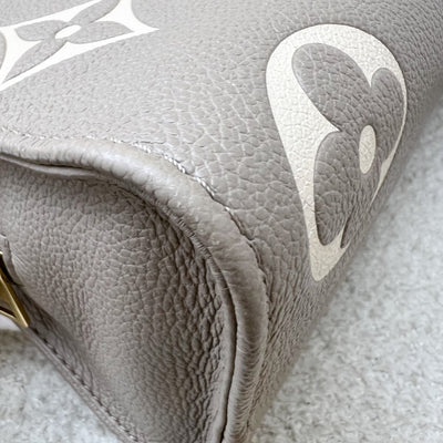 LV Onthego East West in Tourterelle (Grey) / Creme Giant Monogram Empreinte Leather and GHW (Model: M23641)