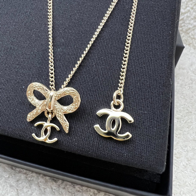 Chanel 25K Bow and Dangling Logo Necklace in SHW (Model: ABG556)