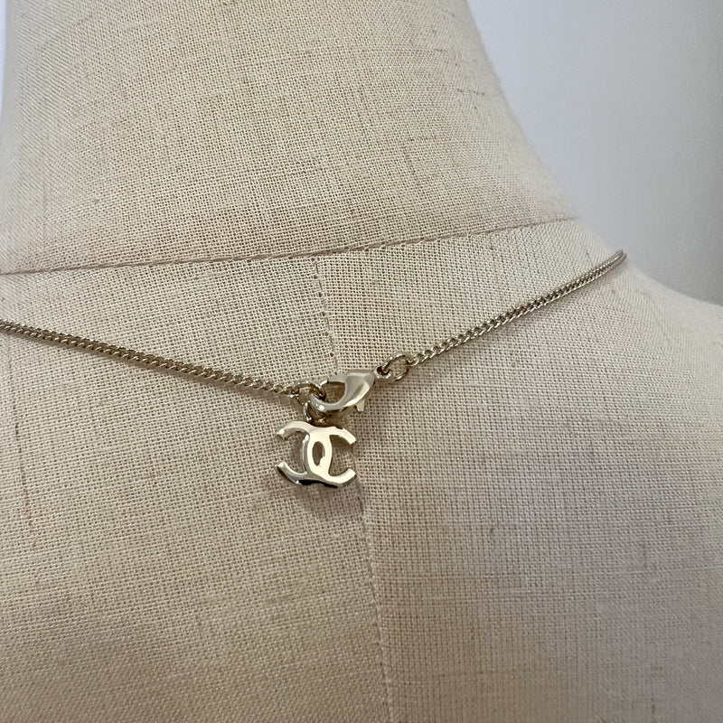 Chanel 25K Bow and Dangling Logo Necklace in SHW (Model: ABG556)