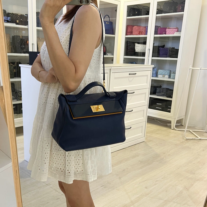 Hermes 24/24 29 Verso Bag in Bleu Saphir Maurice Leather, Navy and Sesame Swift Leather and GHW