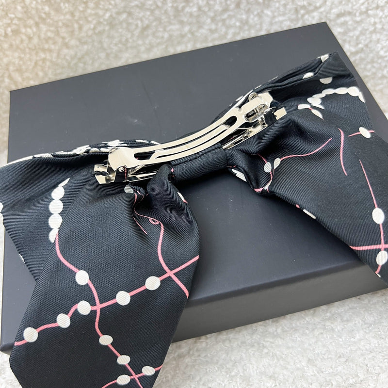 Chanel 23K Printed Pearl Motifs Bow Hair Clip in Black and Off White Fabric with Silver French Barrette