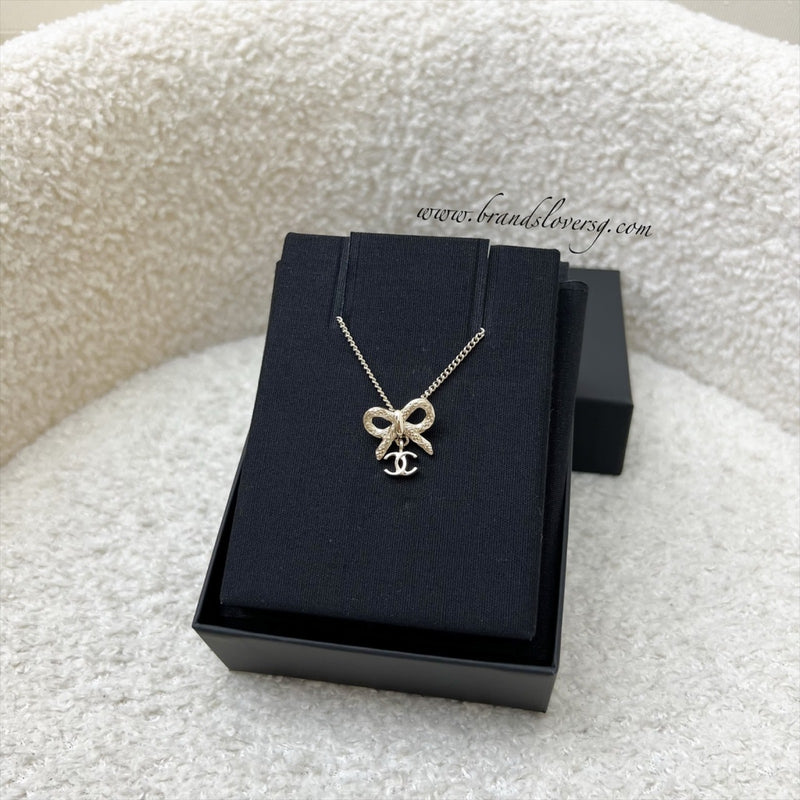 Chanel 25K Bow and Dangling Logo Necklace in SHW (Model: ABG556)